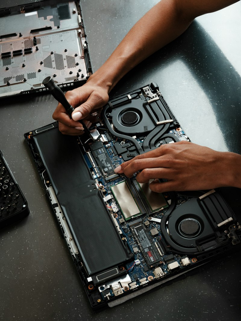 Technician repairing a laptop at Express IT Solutions workshop in Porvorim, Goa